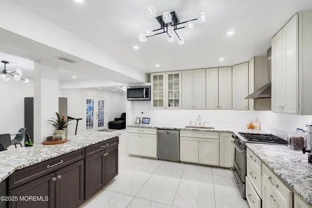 a kitchen with a sink counter top space appliances and cabinets