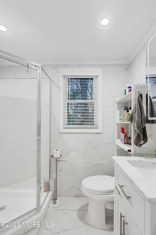 a bathroom with a toilet sink and shower