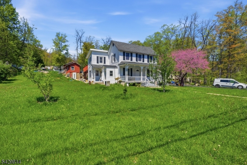 251 Russia Road Oak Ridge, NJ 07438 - Photo 3 of 34 a front view of a house with a garden