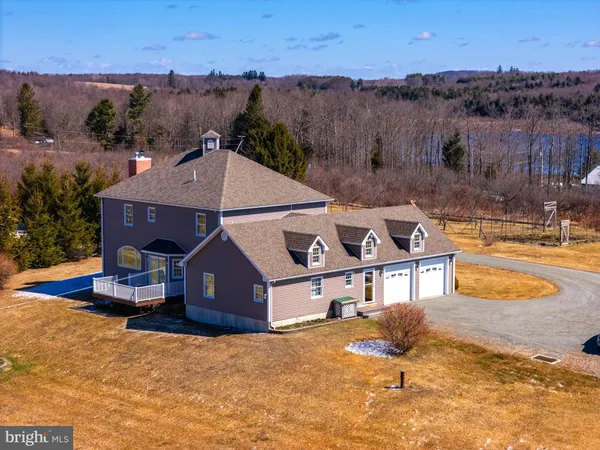 an aerial view of a house with a yard