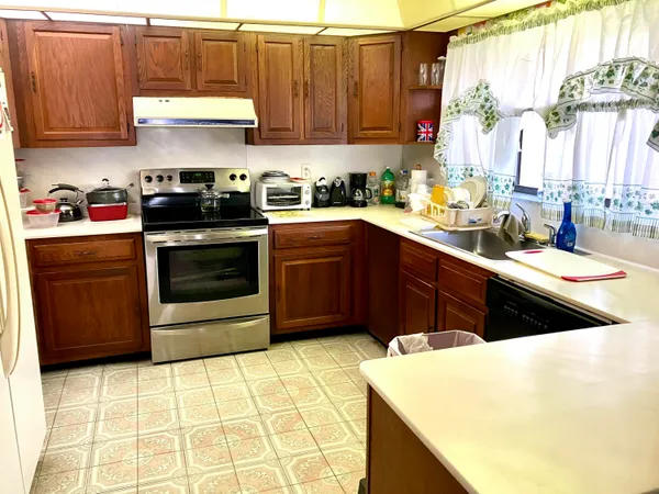 a kitchen with a sink stove and cabinets
