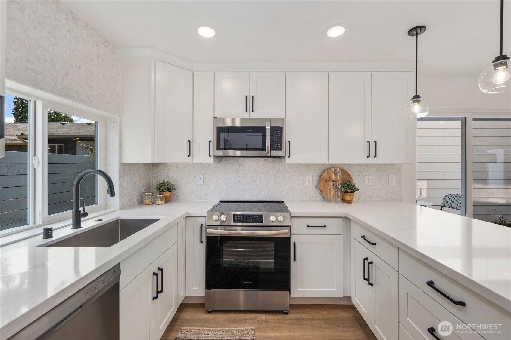 820 South Sullivan Street Seattle, WA 98108 - Photo 4 of 16 a kitchen with granite countertop a sink stainless steel appliances and cabinets