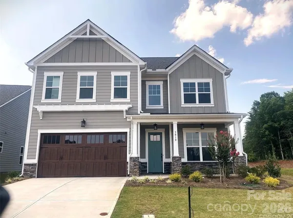 a front view of a house with a yard outdoor seating and garage