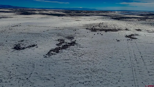 a view of a road with wooden fence