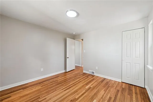 a view of room with wooden floor