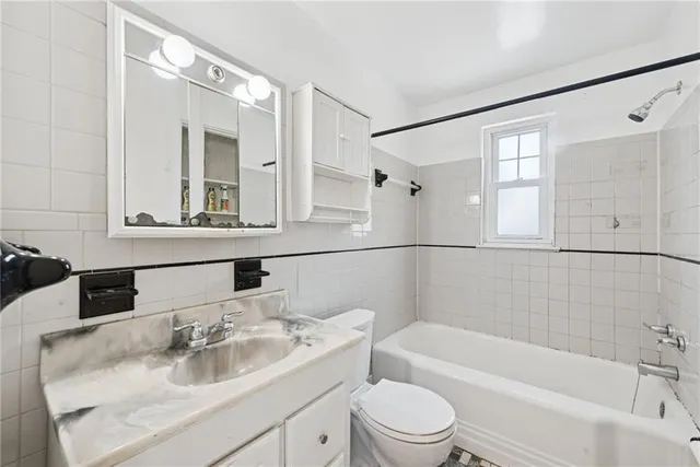 a bathroom with a sink mirror toilet and bathtub