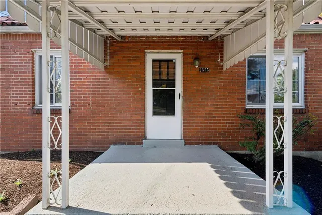 a view of a brick house with windows
