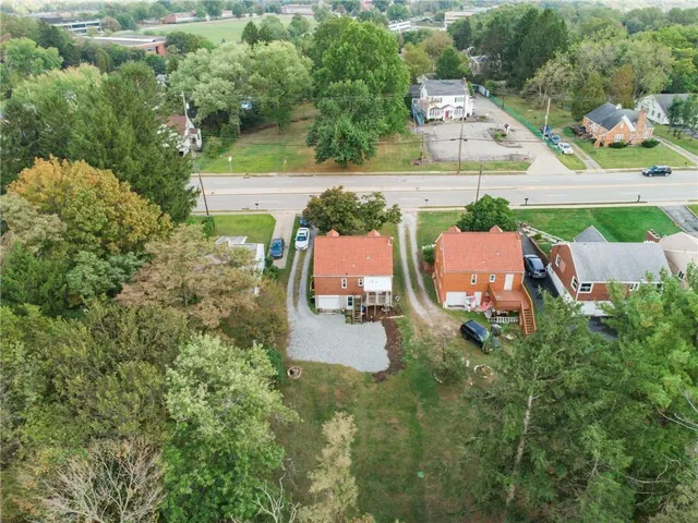 an aerial view of a house with outdoor space