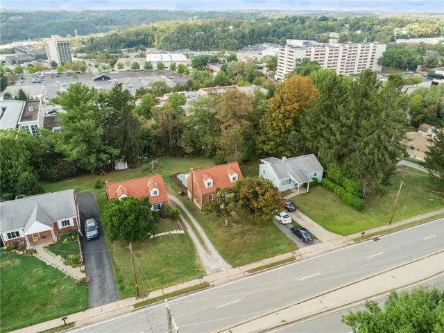 an aerial view of residential houses with outdoor space and river
