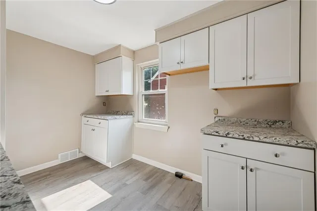 a kitchen with cabinets appliances and a counter space