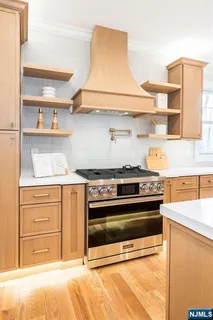 a kitchen with stainless steel appliances a refrigerator and a stove top oven