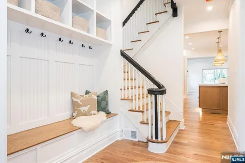 a view of entryway and hall with wooden floor