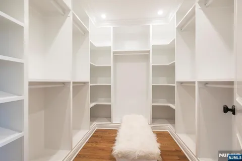 a spacious bathroom with a double vanity sink a mirror and a bathtub