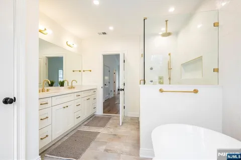 a large spacious bathroom with a bathtub and shower