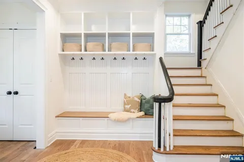 a view of entryway with wooden floor and front door