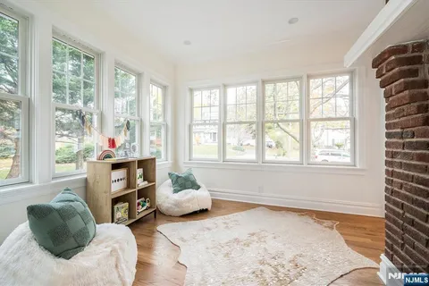 a living room with furniture and a floor to ceiling window