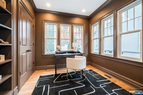 a large kitchen with kitchen island a large counter top and stainless steel appliances