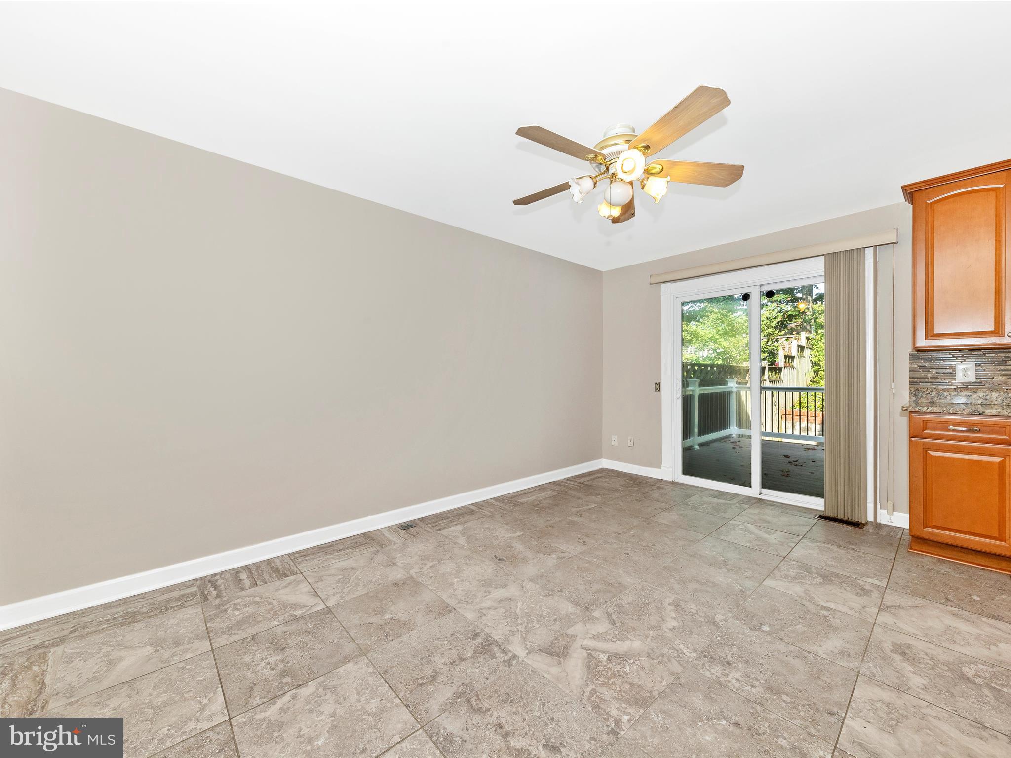314 Crescendo Way Silver Spring, MD 20901 - Photo 13 of 57 an empty room with windows and ceiling fan