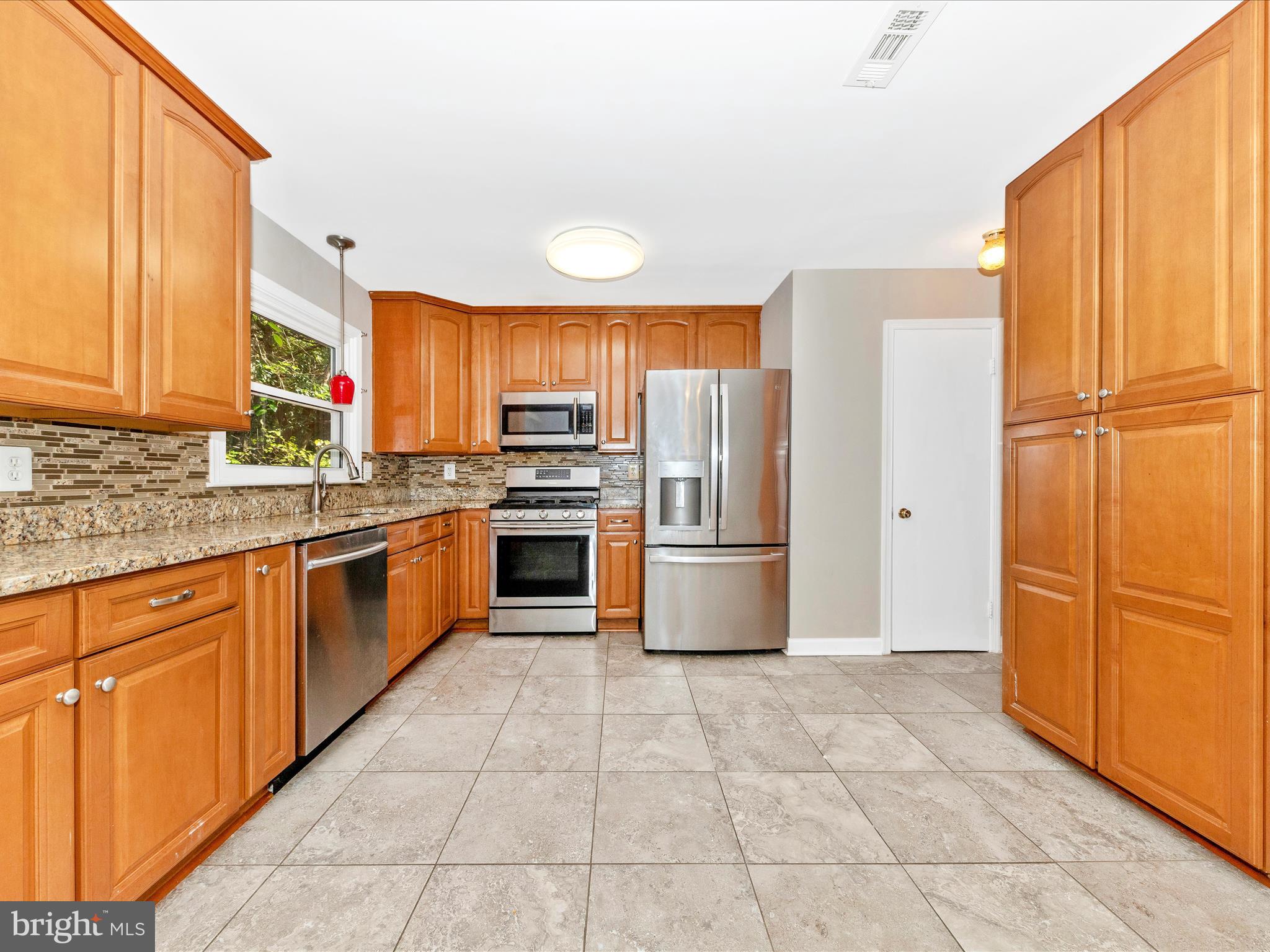 314 Crescendo Way Silver Spring, MD 20901 - Photo 15 of 57 a kitchen with stainless steel appliances granite countertop a refrigerator sink and cabinets