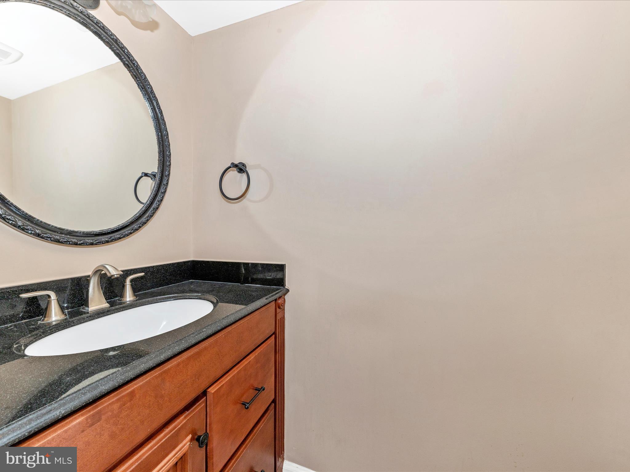 314 Crescendo Way Silver Spring, MD 20901 - Photo 19 of 57 a bathroom with a granite countertop sink and a mirror