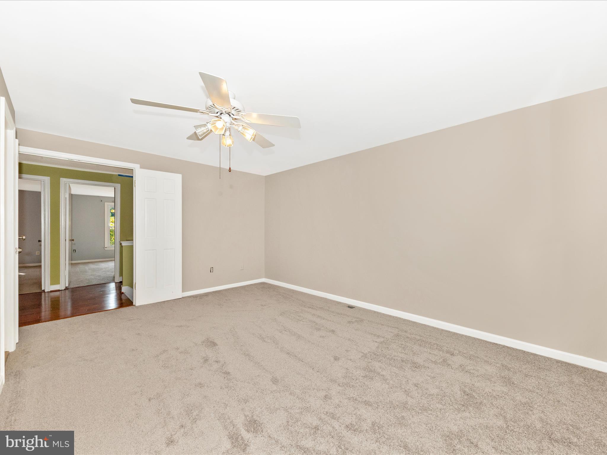 314 Crescendo Way Silver Spring, MD 20901 - Photo 25 of 57 an empty room with a chandelier fan and windows