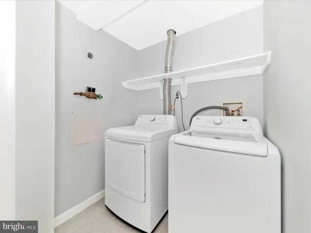 front view of a brick house with a large tree