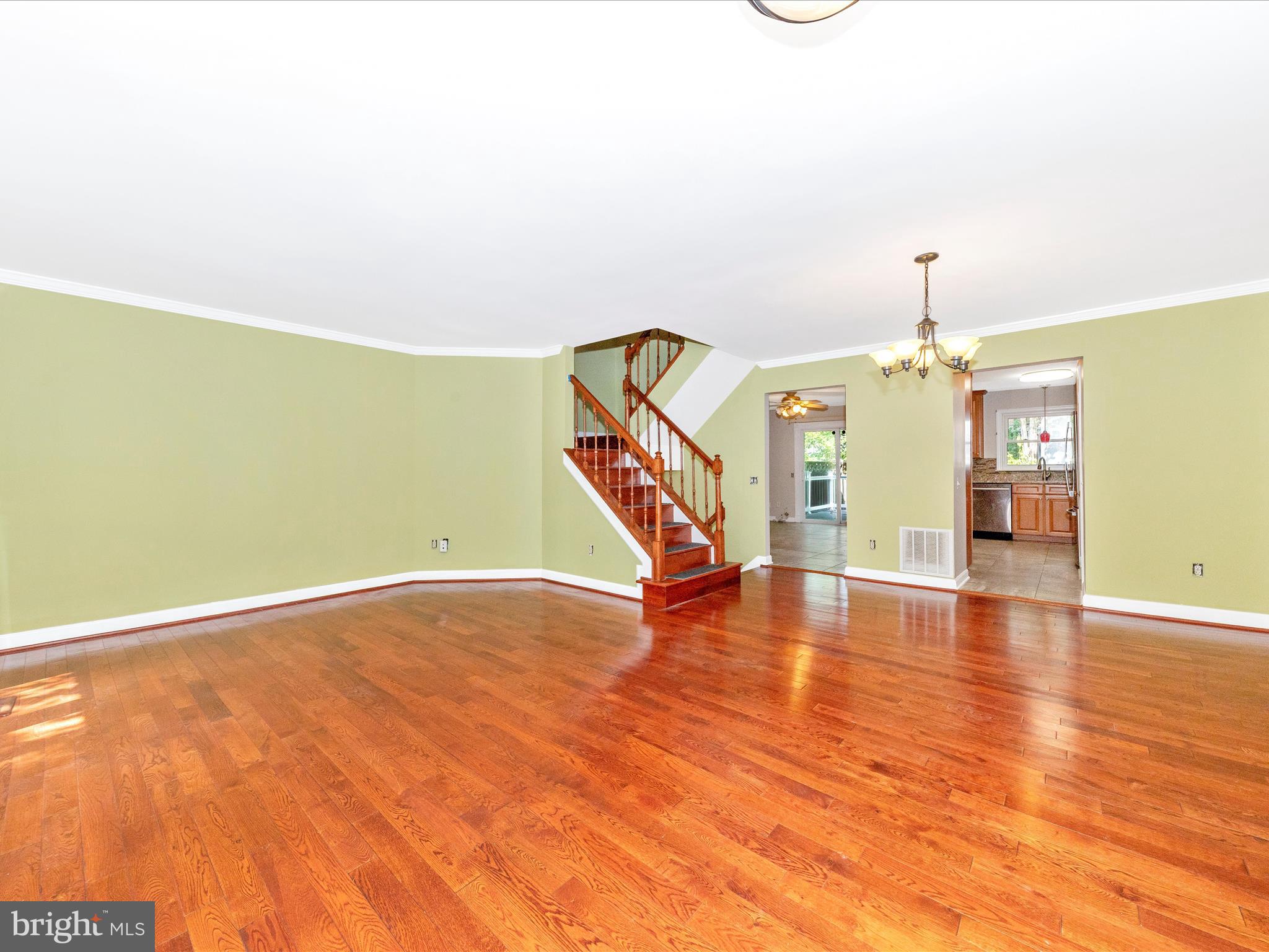 314 Crescendo Way Silver Spring, MD 20901 - Photo 4 of 57 a view of an empty room with wooden floor and stairs
