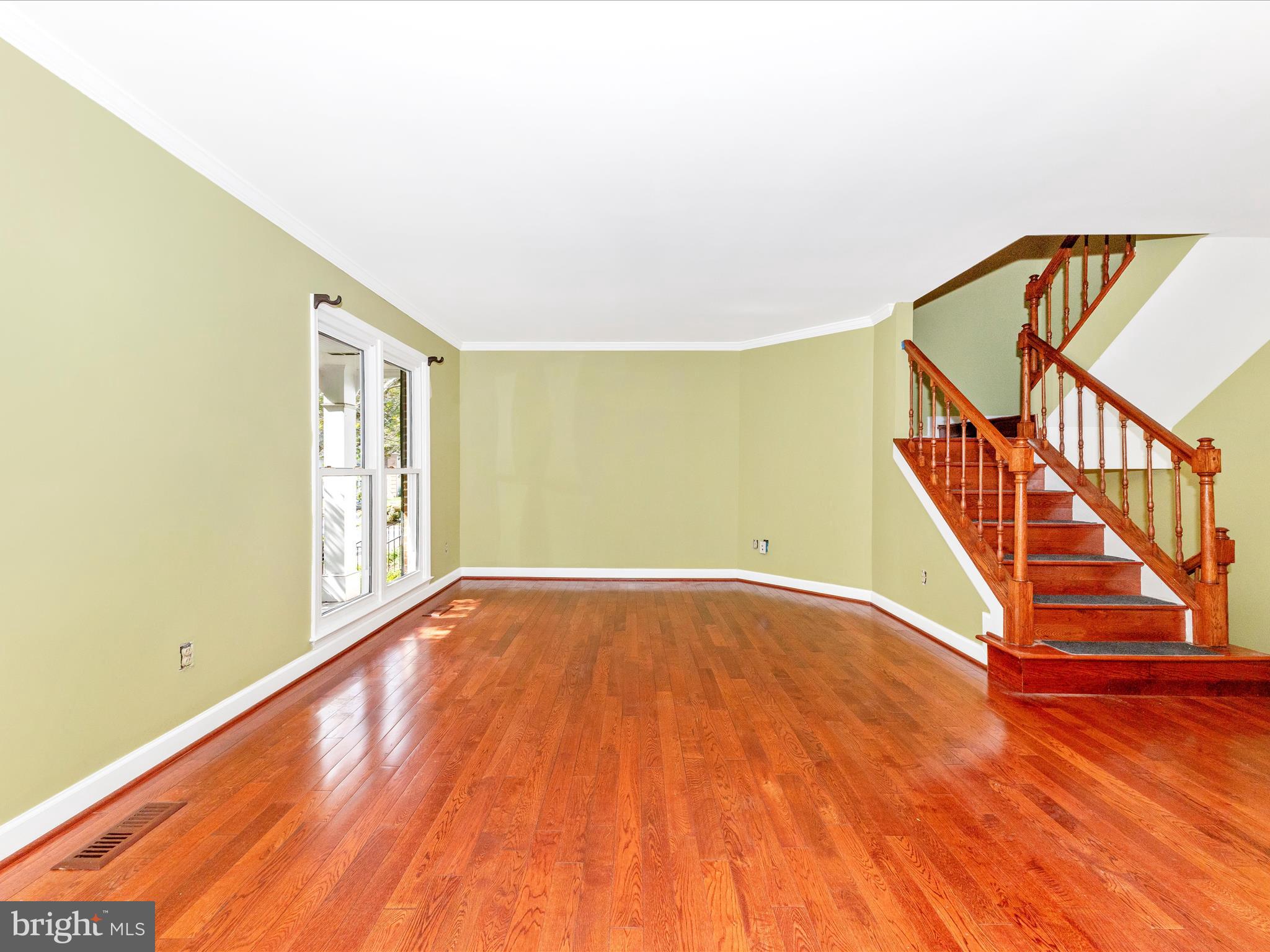 314 Crescendo Way Silver Spring, MD 20901 - Photo 5 of 57 a view of an empty room with wooden floor and stairs