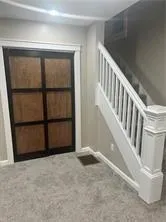 a view of an empty room with stairs