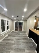 a large room with a bed and a large window