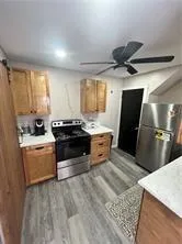 a kitchen with a stove a refrigerator and a sink
