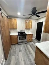 a kitchen with stainless steel appliances a sink a stove a refrigerator and cabinets