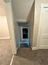 an empty room with a fireplace and cabinet
