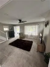 a large bed sitting in a room next to a lamp and a large window