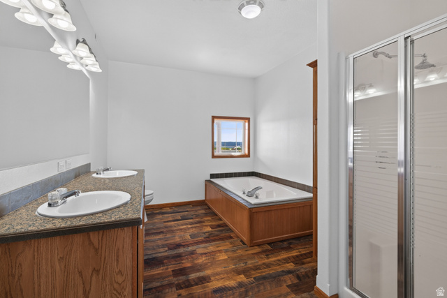 1 Tobe Day Road La Sal, UT 84530 - Photo 51 of 67 Bathroom featuring a double vanity with stone-finish countertops, wood-finish cabinetry, and wall-mounted light fixtures
