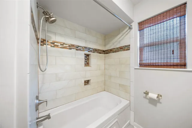 a bathroom with a bathtub and shower