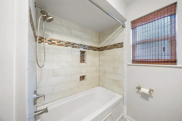 a bathroom with a bathtub and shower