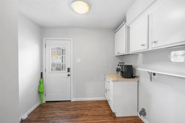 a view of a kitchen with white cabinets