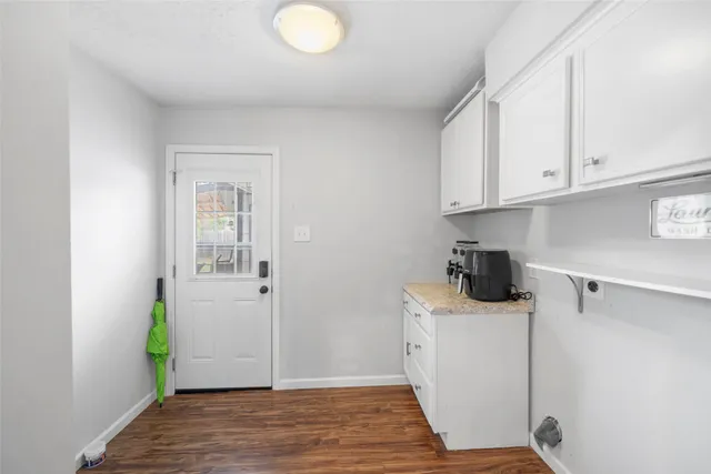 a view of a kitchen with white cabinets
