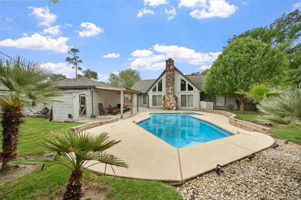 a view of a house with swimming pool and sitting area