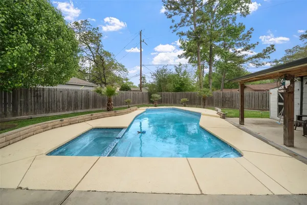 a swimming pool with outdoor seating and yard