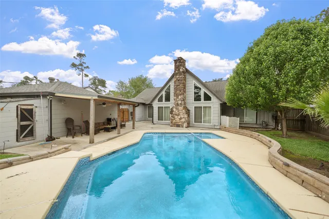 a view of a house with backyard and sitting area