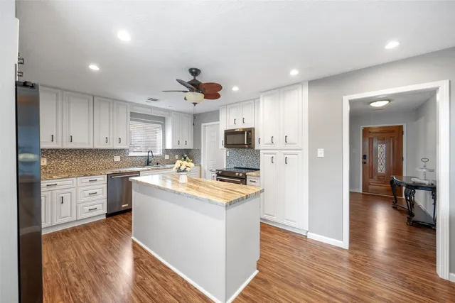 a kitchen with a stove a sink and a refrigerator