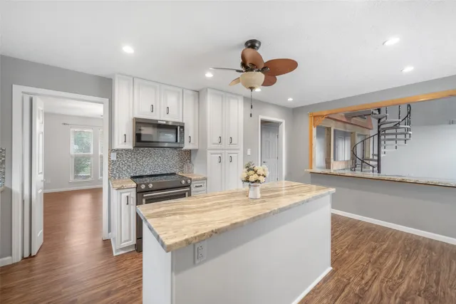 a kitchen with a stove a sink and a refrigerator