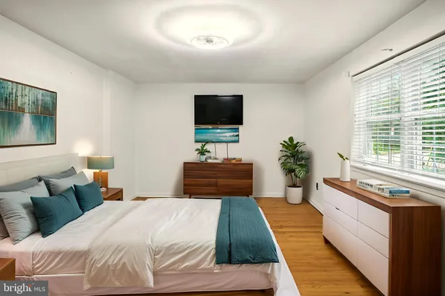 a bedroom with a large bed and a flat screen tv