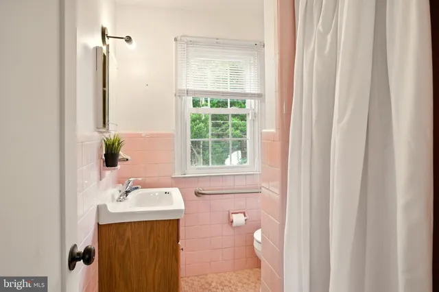 a bathroom with a sink a mirror and a bathtub