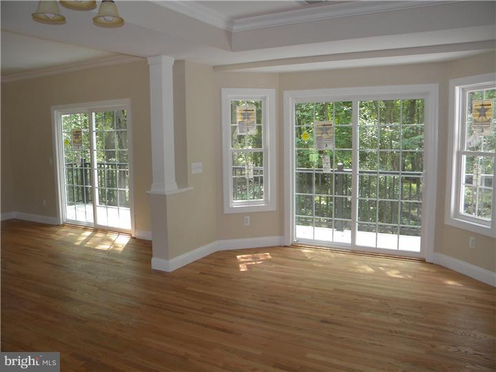 128 Cranbury Road Princeton Junction, NJ 08550 - Photo 12 of 25 a view of an empty room with wooden floor and a window