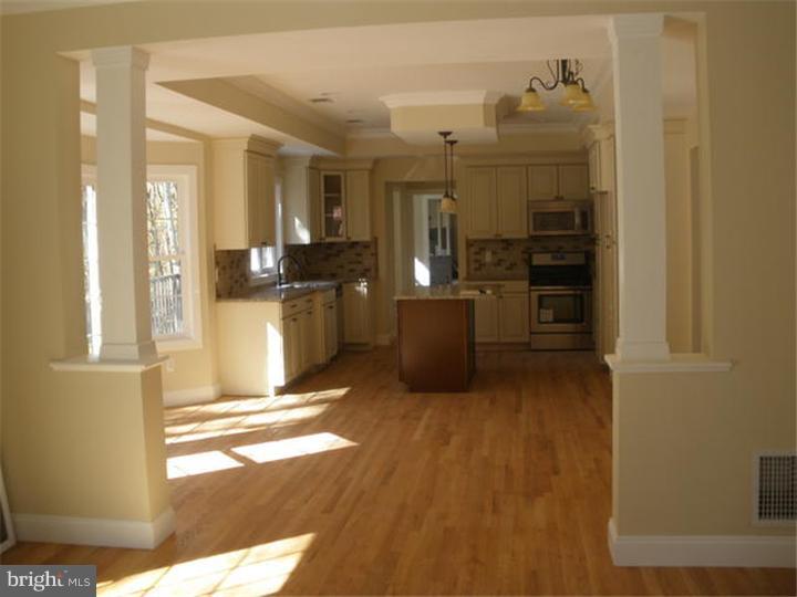128 Cranbury Road Princeton Junction, NJ 08550 - Photo 14 of 25 a view of a kitchen with a refrigerator and cabinets