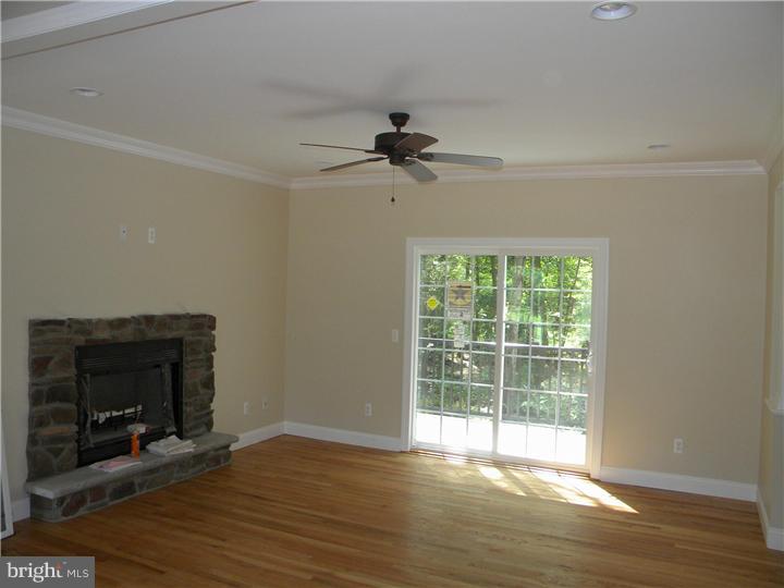 128 Cranbury Road Princeton Junction, NJ 08550 - Photo 15 of 25 a view of an empty room with wooden floor fireplace and a window