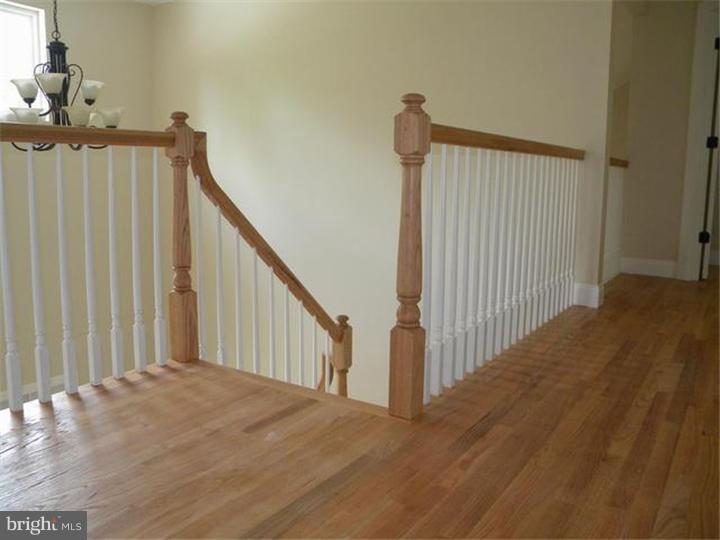 128 Cranbury Road Princeton Junction, NJ 08550 - Photo 17 of 25 a view of a hallway with wooden floor and entryway